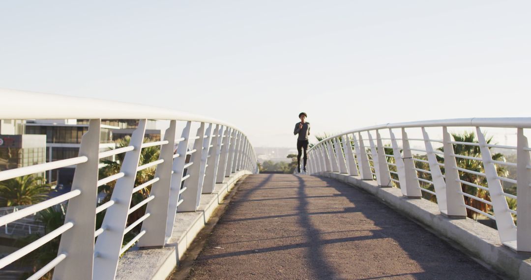 Woman Running on Pedestrian Bridge during Sunset - Free Images, Stock Photos and Pictures on Pikwizard.com