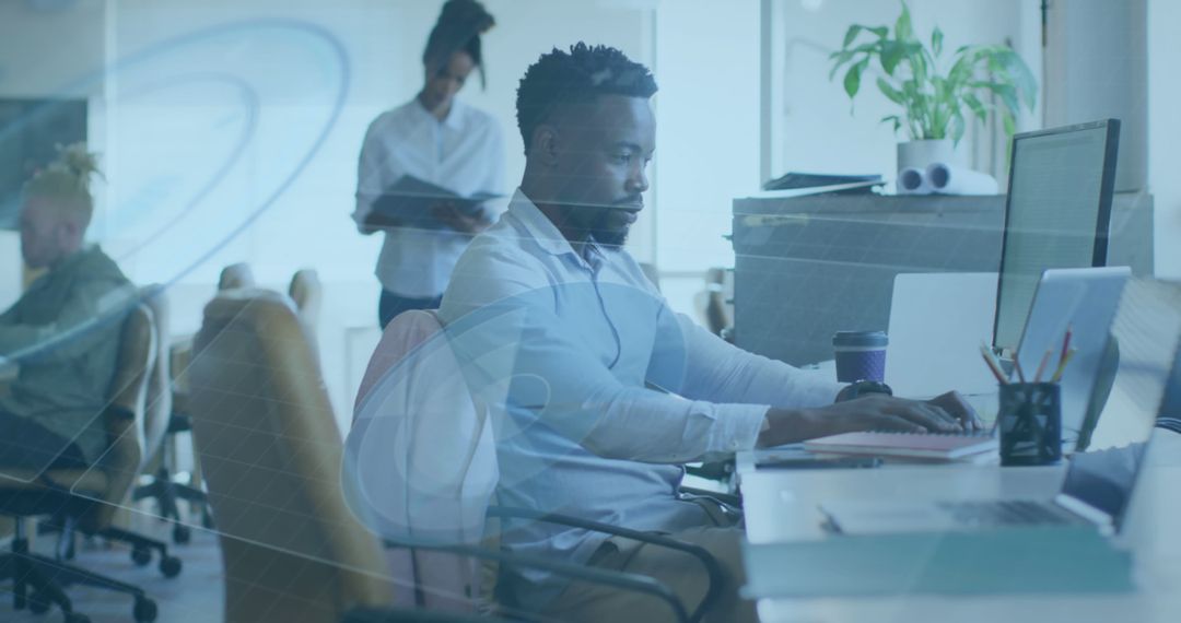 Focused African American Man Working on Computer in Modern Office - Free Images, Stock Photos and Pictures on Pikwizard.com