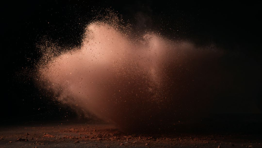 Dynamic Burst of Reddish-Brown Dust Against Dark Background