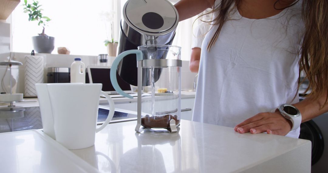 Woman Using French Press for Coffee in Modern Kitchen - Free Images, Stock Photos and Pictures on Pikwizard.com