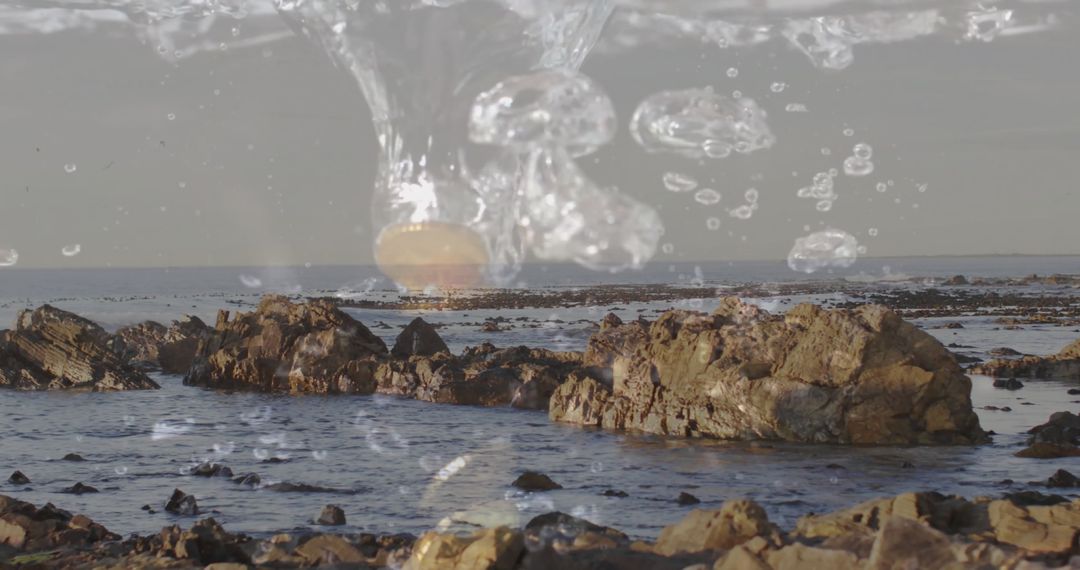 Tranquil Coastal Scene with Bubbles and Jagged Rocks