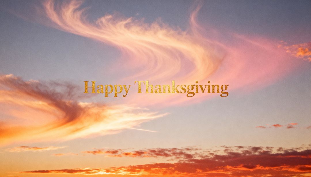 Glowing Gold Happy Thanksgiving Text Floating Over Pastel Sunset Sky with Wispy Clouds