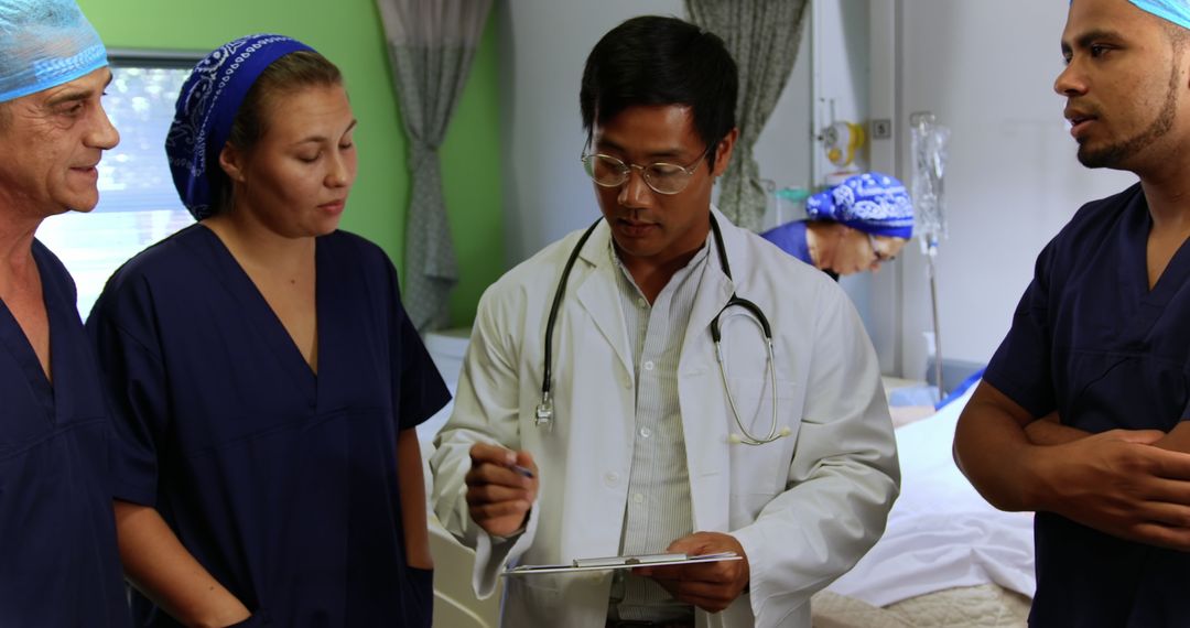 Multiracial Medical Team Discussing Patient Care Plan in Hospital - Free Images, Stock Photos and Pictures on Pikwizard.com