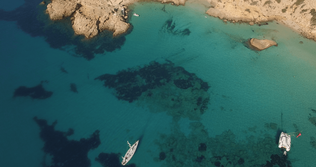 Idyllic Aerial Coastal View with Boats in Transparent Blue Waters