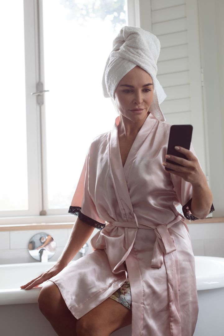 Woman in Bathrobe Taking Selfie in Bathroom - Free Images, Stock Photos and Pictures on Pikwizard.com