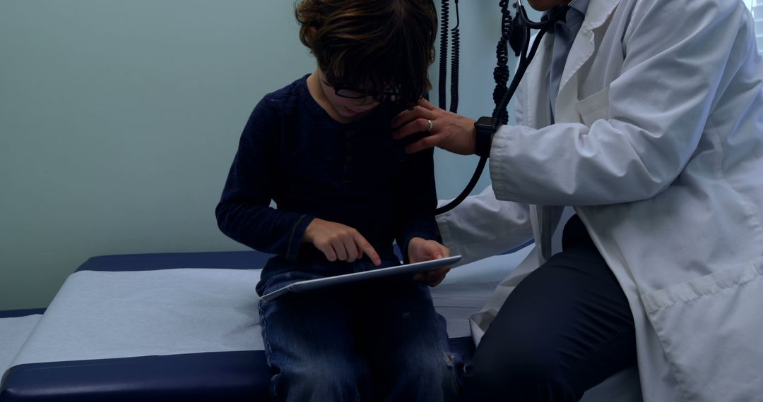 Pediatrician Examining Child Using Tablet in Medical Office - Free Images, Stock Photos and Pictures on Pikwizard.com