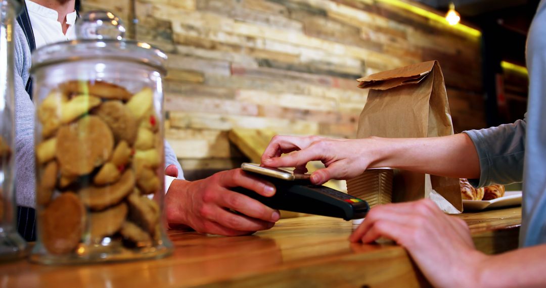 Customer Paying with Smartphone at Rustic Bakery Counter - Free Images, Stock Photos and Pictures on Pikwizard.com