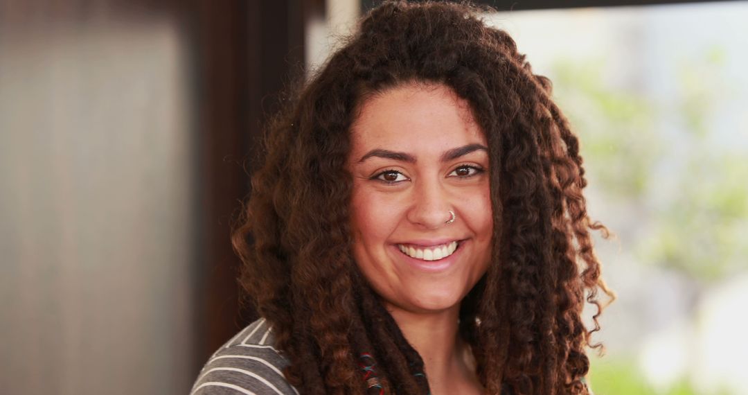 Portrait of Smiling Woman with Dreadlocks Indoors - Free Images, Stock Photos and Pictures on Pikwizard.com