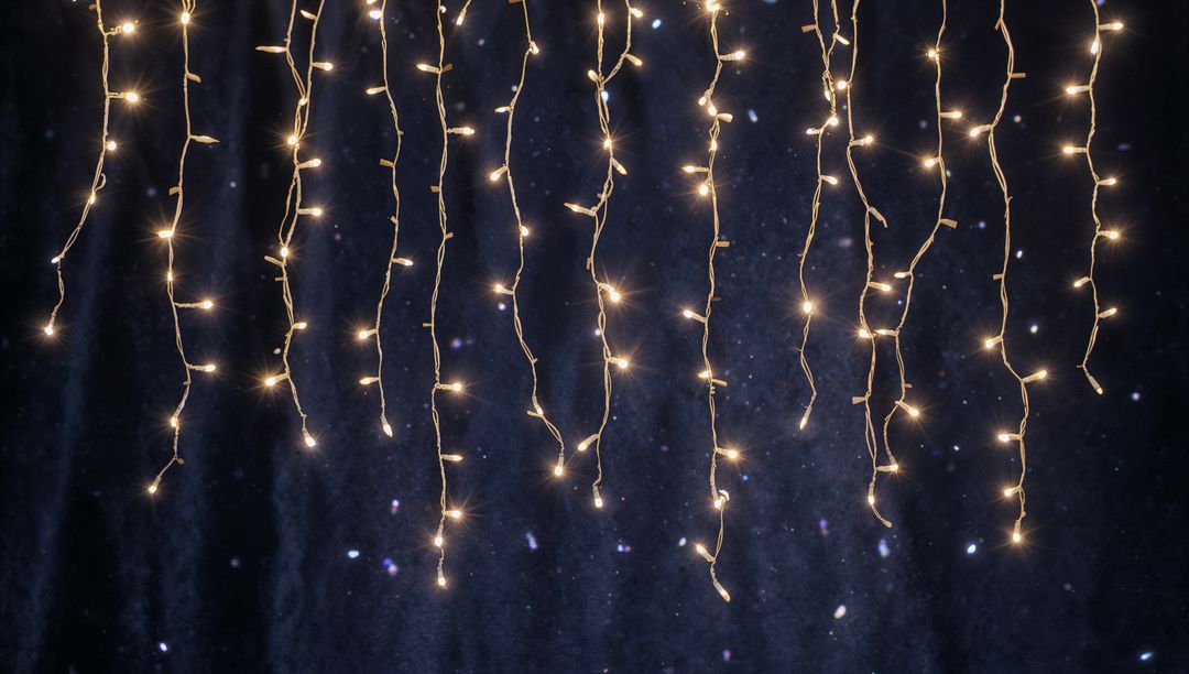 Warm White Fairy Light Curtains Hanging Over Dark Navy Backdrop Creating Festive Twinkle Bokeh