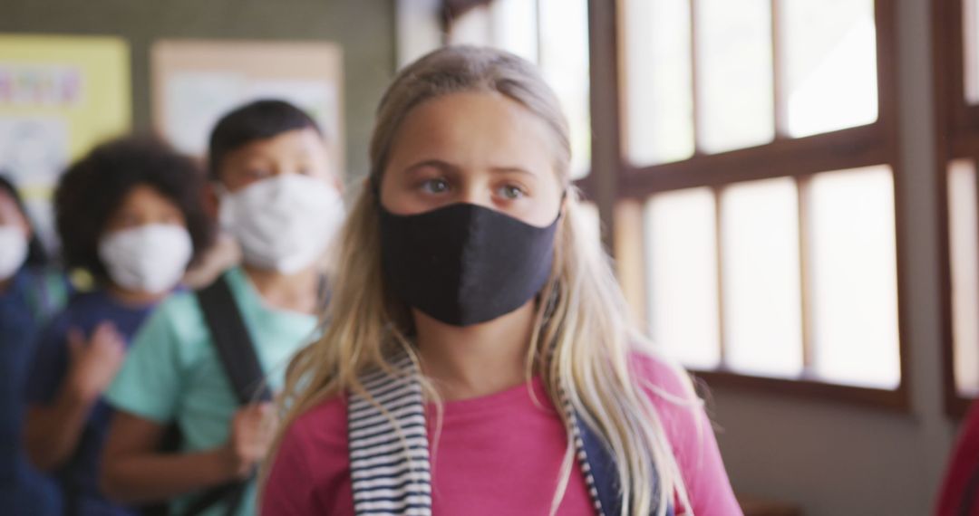 Masked Schoolgirl Facing Forward in Classroom Environment