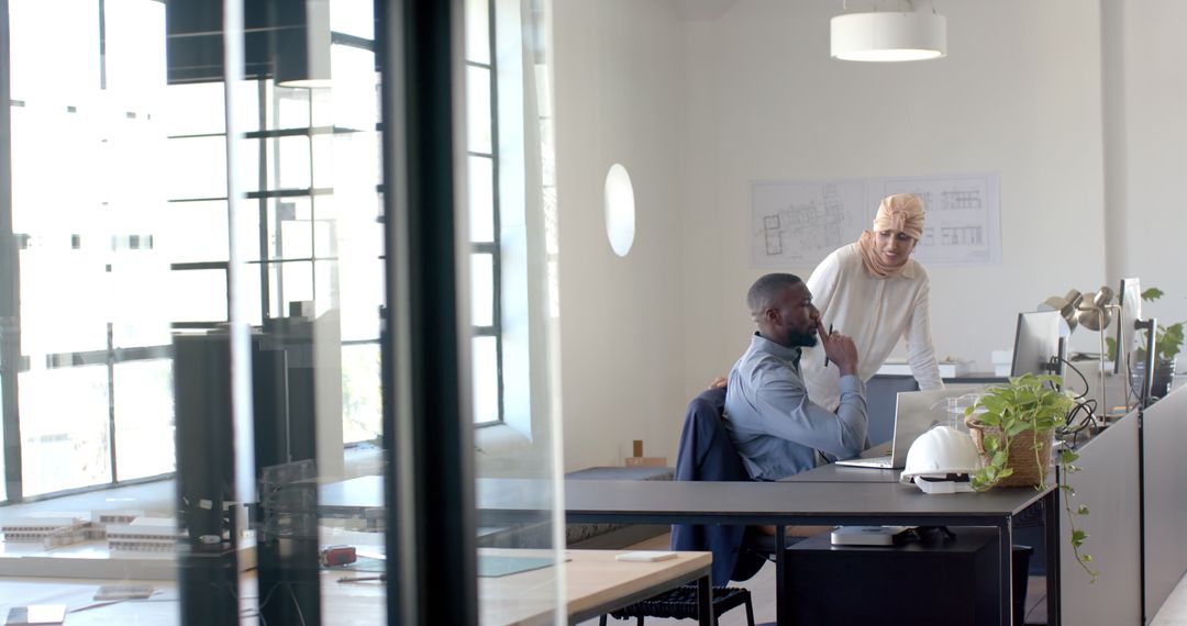 Diverse Team Collaborating on Technical Project in Modern Office
