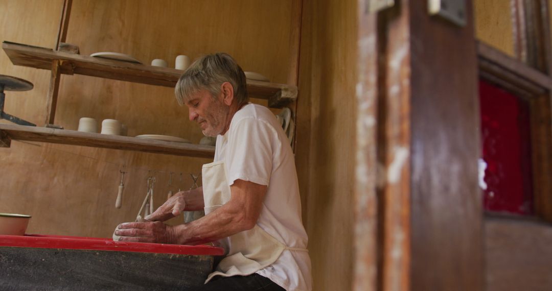 Senior Man Making Pottery in Workshop Senior Creativity