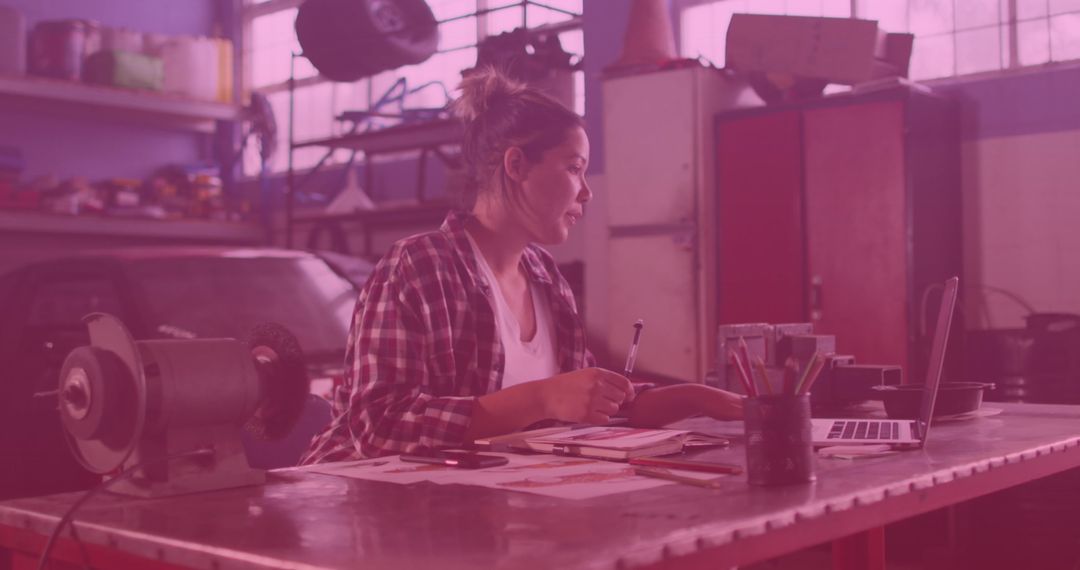 Biracial Woman Multitasking with Technology in Workshop Setting