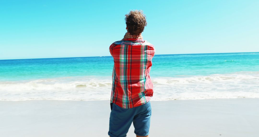 Man Enjoying Serene Beach View in Casual Outfit on Sunny Day - Free Images, Stock Photos and Pictures on Pikwizard.com