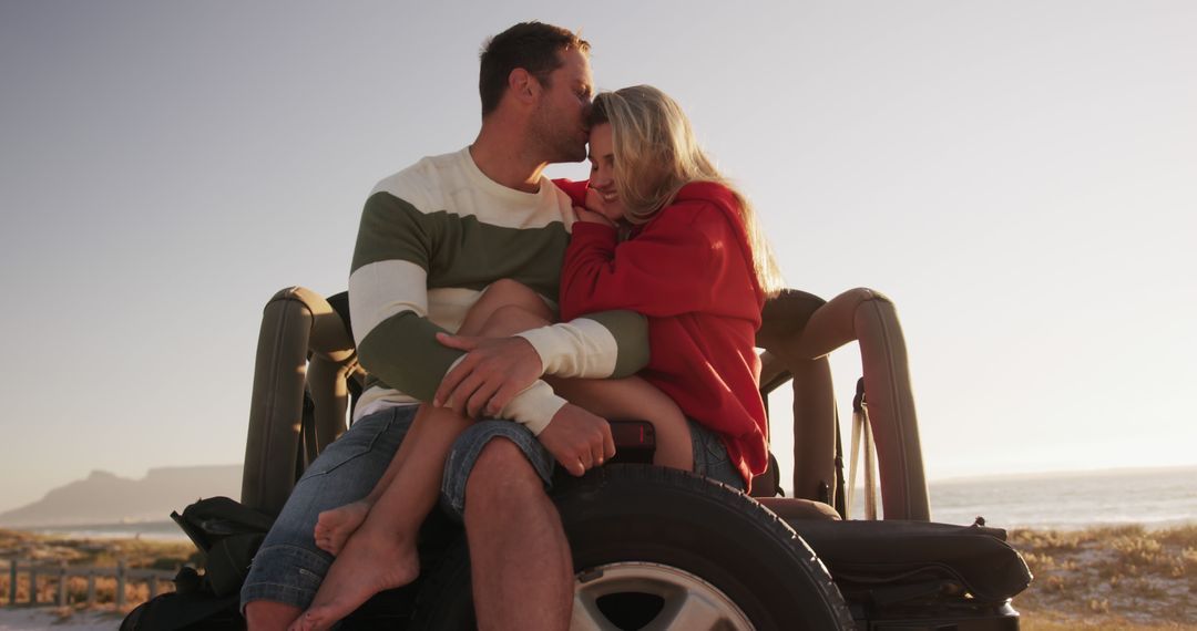 Romantic Couple Kissing on Off-Road Vehicle at Beach Sunset - Free Images, Stock Photos and Pictures on Pikwizard.com