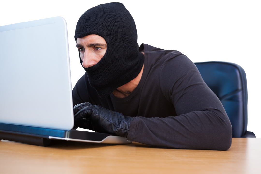 Masked Intruder Hacking on Laptop with Stealthy Intent - Download Free Stock Images Pikwizard.com