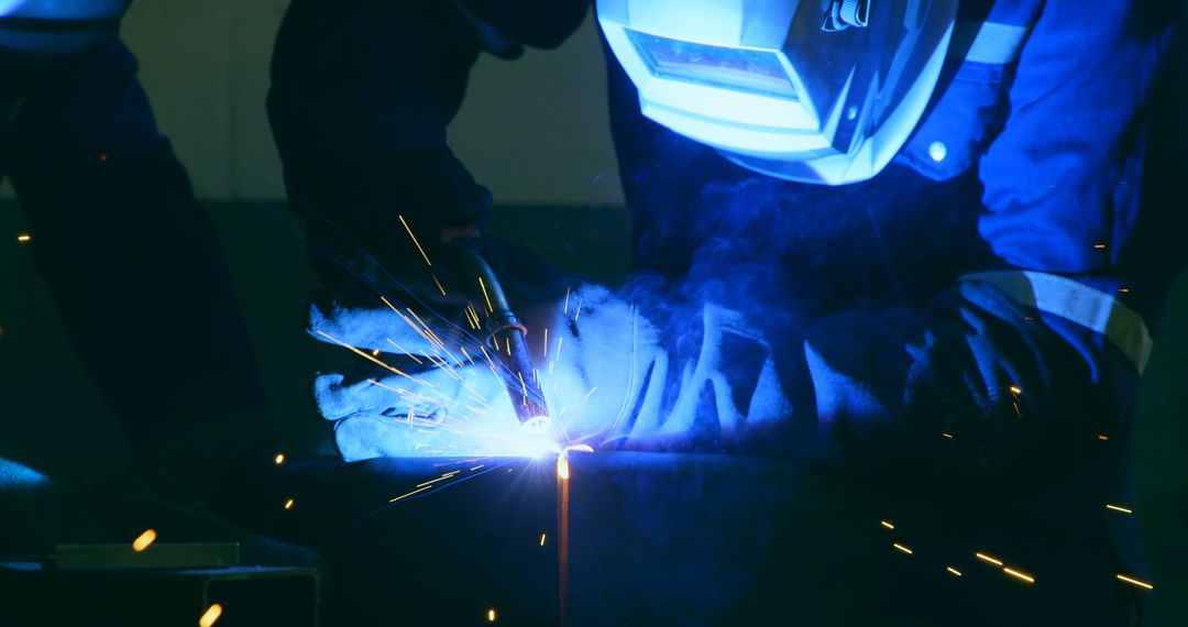 Industrial Worker Using Welding Torch with Sparks - Free Images, Stock Photos and Pictures on Pikwizard.com