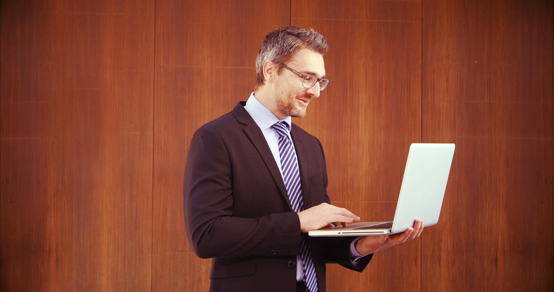 Confident Businessman Using Laptop in Office - Free Images, Stock Photos and Pictures on Pikwizard.com