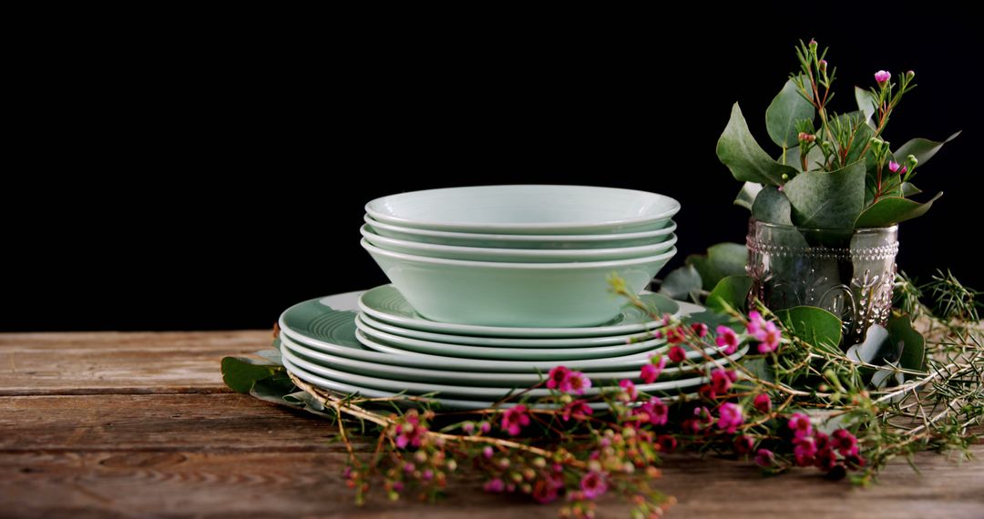 Stacked Green Plates with Flowers on Rustic Wooden Table - Free Images, Stock Photos and Pictures on Pikwizard.com