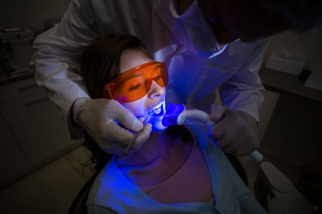 Dentist examining a female patient with dental tool - Free Images, Stock Photos and Pictures on Pikwizard.com