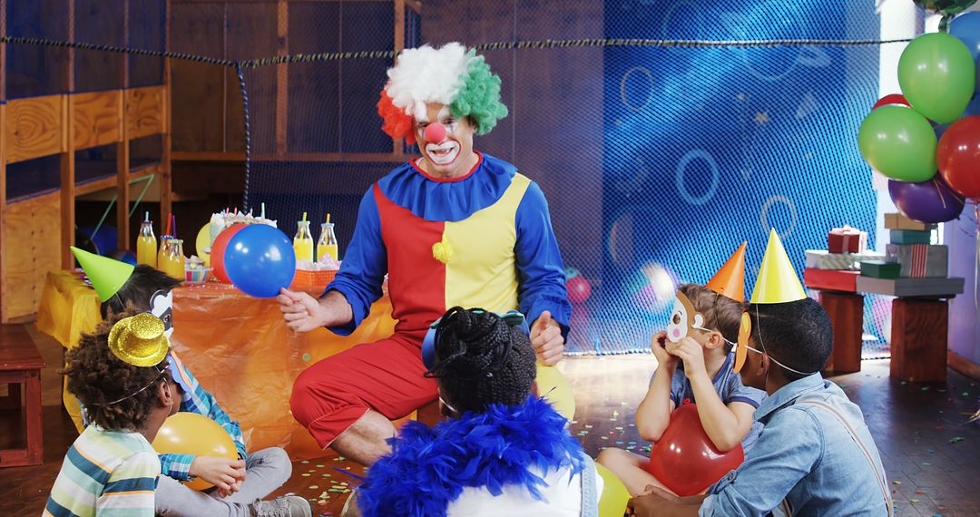 A clown entertains a diverse group of children at a birthday party, with copy space - Free Images, Stock Photos and Pictures on Pikwizard.com