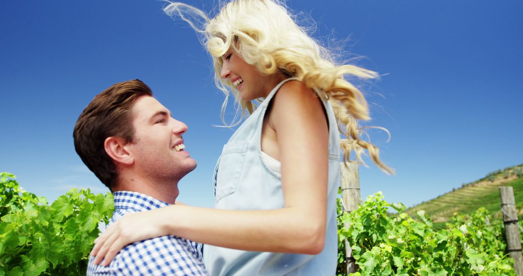 Romantic Couple Embracing Outdoors Under Clear Blue Sky - Free Images, Stock Photos and Pictures on Pikwizard.com