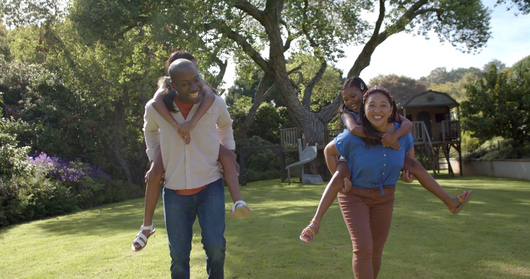 Family of Four Enjoying Playful Afternoon in Sunny Garden