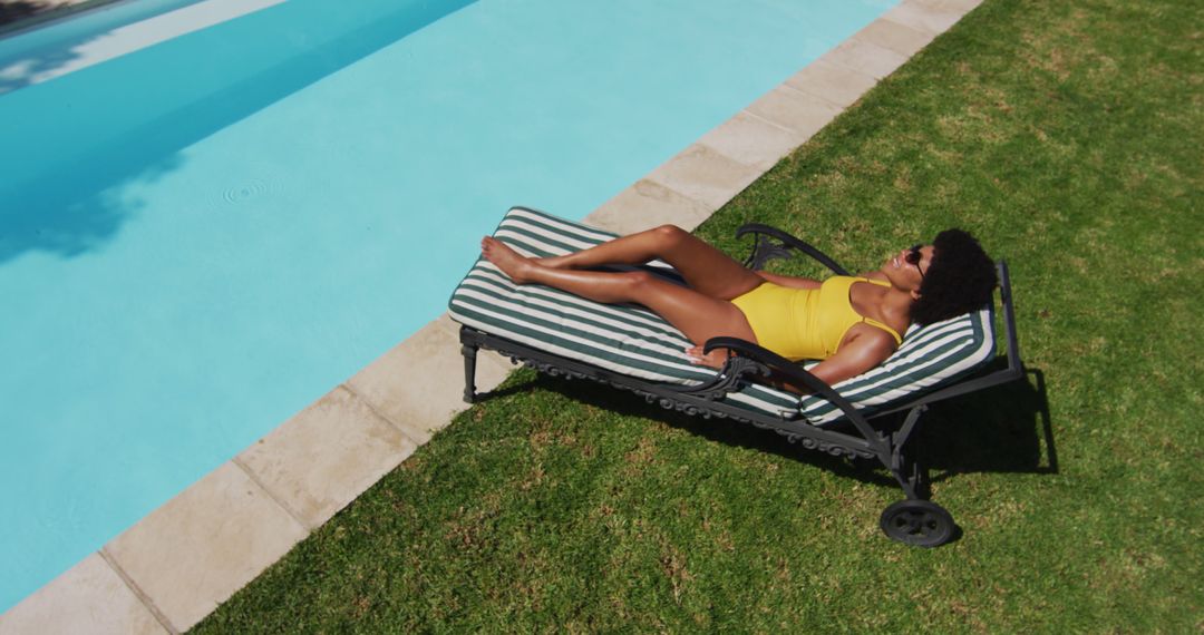 Woman Sunbathing by Poolside Lounger in Yellow Swimsuit - Free Images, Stock Photos and Pictures on Pikwizard.com