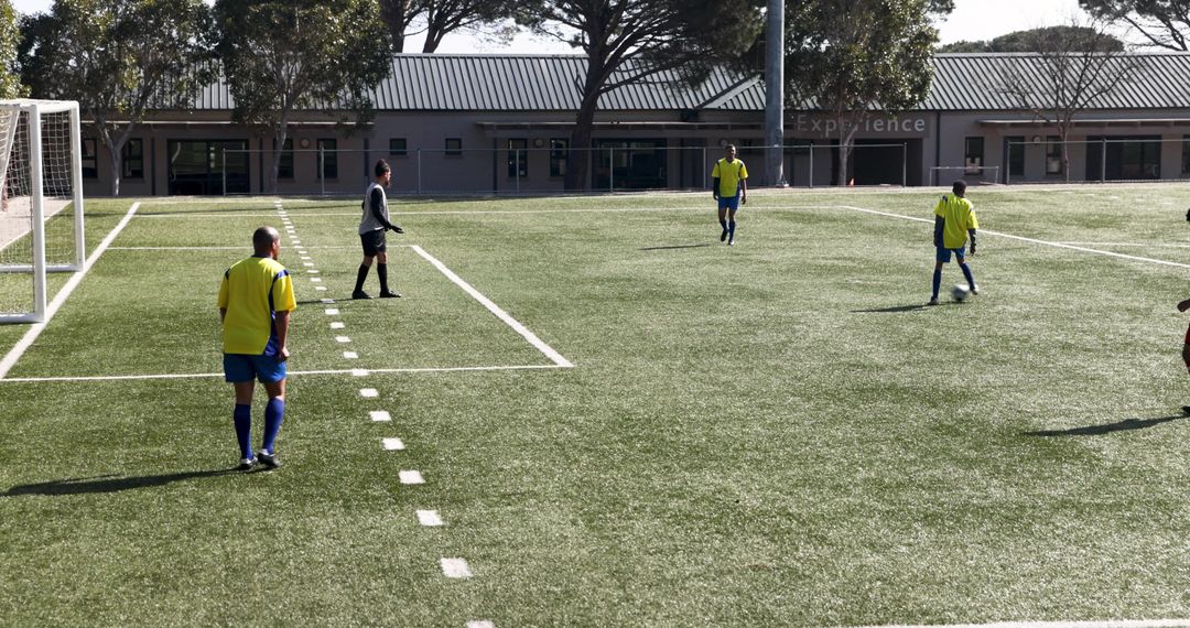 Soccer Players in Action on Summer Field during Training Session