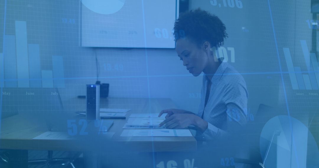Businesswoman analyzing data, pointing at charts on conference table with analytics overlay
