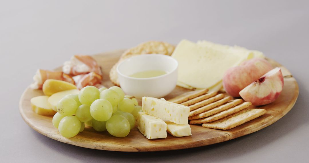 Assorted Cheese Platter with Fruits, Crackers, and Honey - Free Images, Stock Photos and Pictures on Pikwizard.com