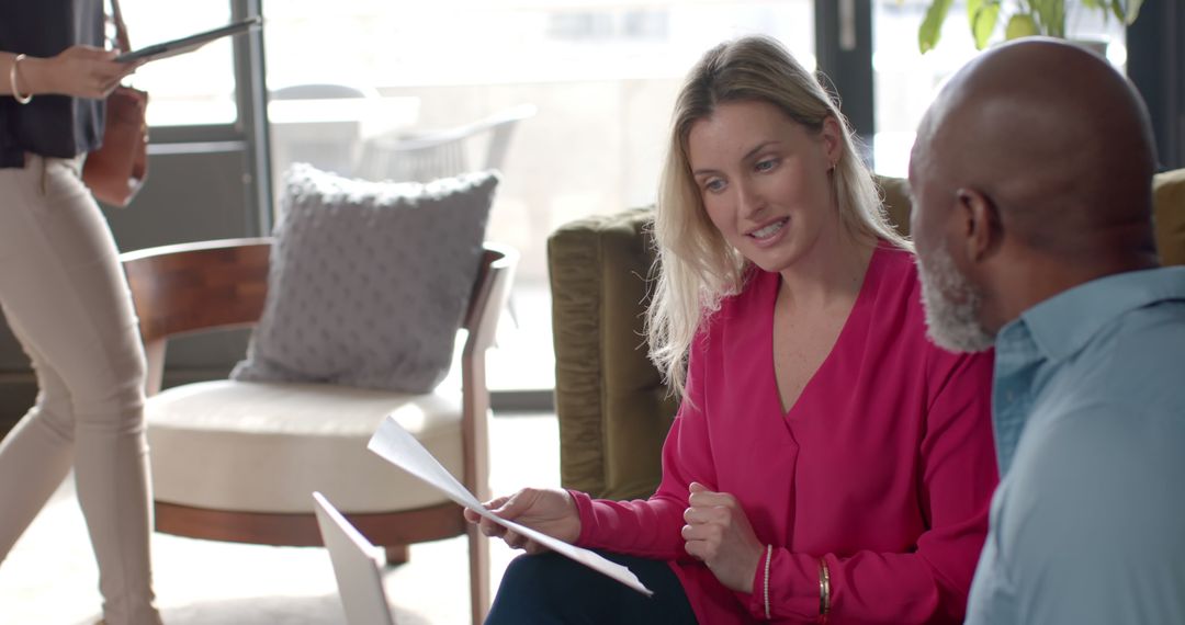 Diverse Business Professionals Discuss Project in Modern Office