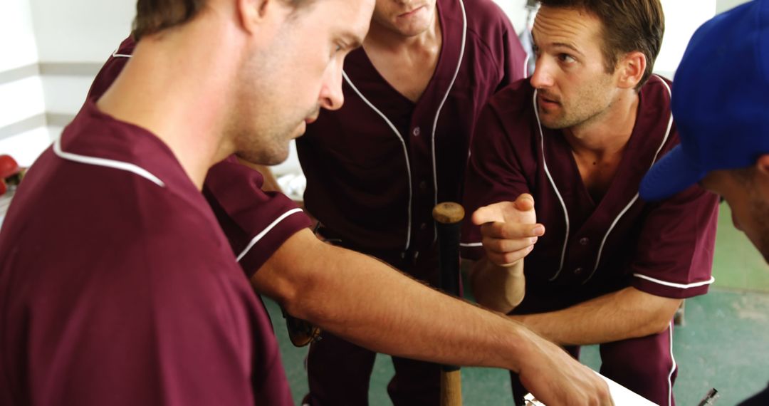 Baseball Team Strategizing with Coach in Dugout - Free Images, Stock Photos and Pictures on Pikwizard.com