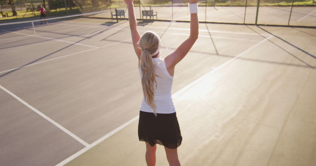 Image of back of caucasian female tennis player holding racket and hitting ball - Free Images, Stock Photos and Pictures on Pikwizard.com