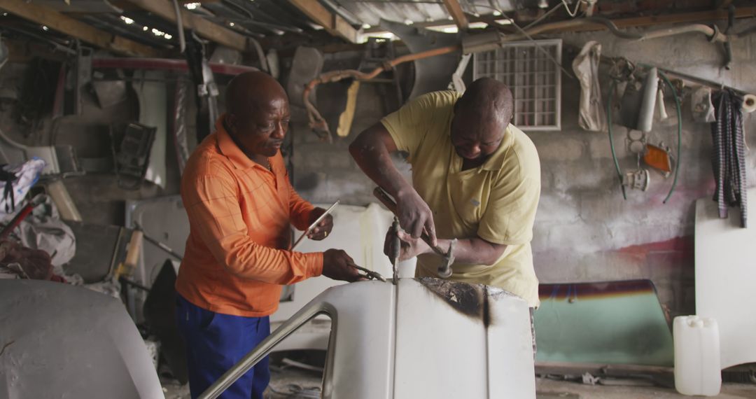 Two Black Men Repairing Car In Autobody Workshop - Free Images, Stock Photos and Pictures on Pikwizard.com