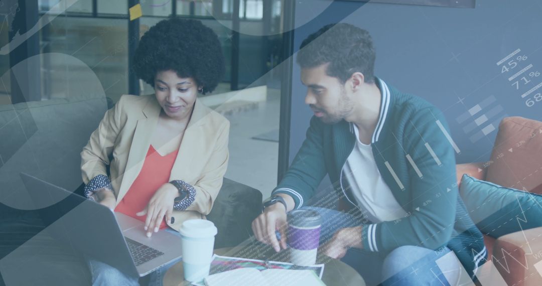 Diverse Colleagues Collaborating Over Financial Data in Modern Office