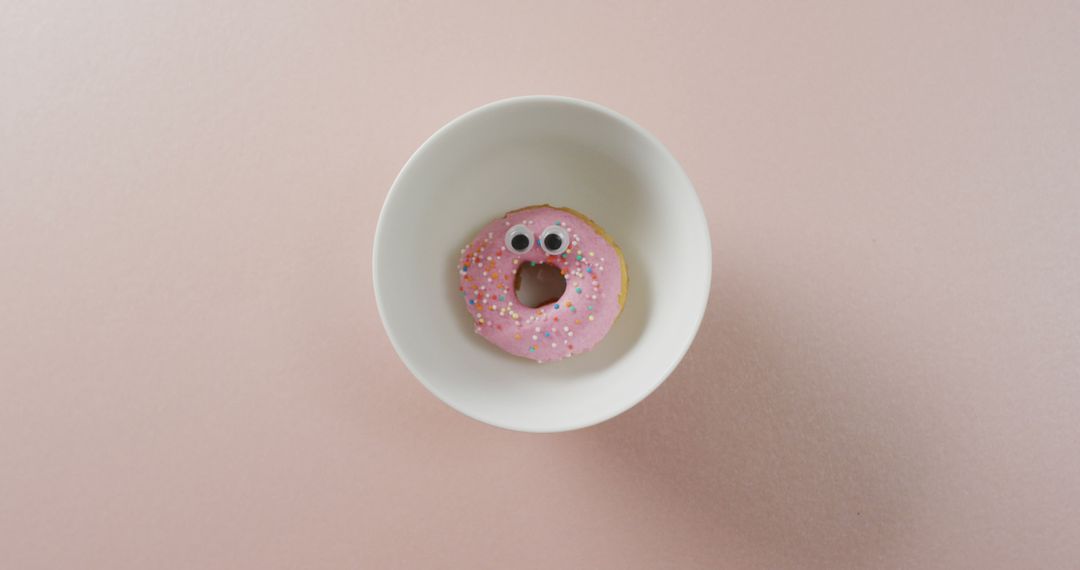 Pink Frosted Donut with Googly Eyes in White Bowl - Free Images, Stock Photos and Pictures on Pikwizard.com