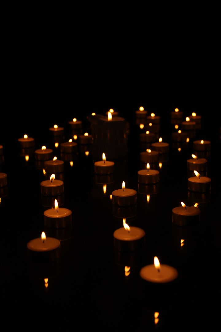 Glowing tea light candles in dark ambiance - Free Images, Stock Photos and Pictures on Pikwizard.com