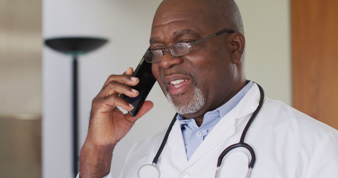 Friendly African American Doctor Talking on Phone in Office - Free Images, Stock Photos and Pictures on Pikwizard.com