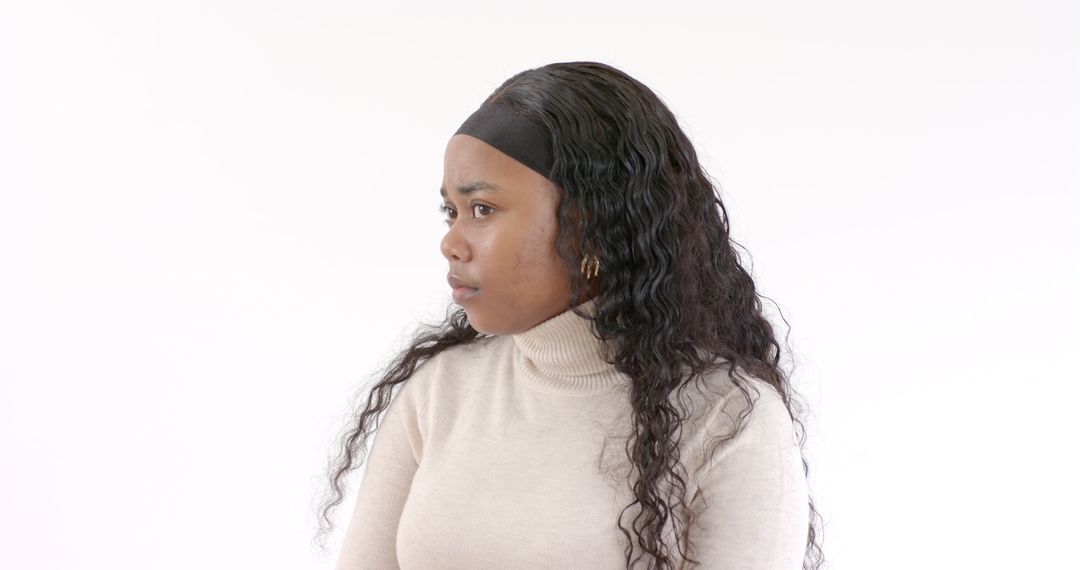 Thoughtful Woman in Turtleneck Against White Backdrop