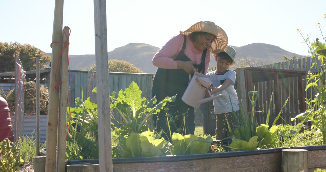 Woman Gardening with Child, Planting and Watering Vegetables in Outdoor Garden - Free Images, Stock Photos and Pictures on Pikwizard.com