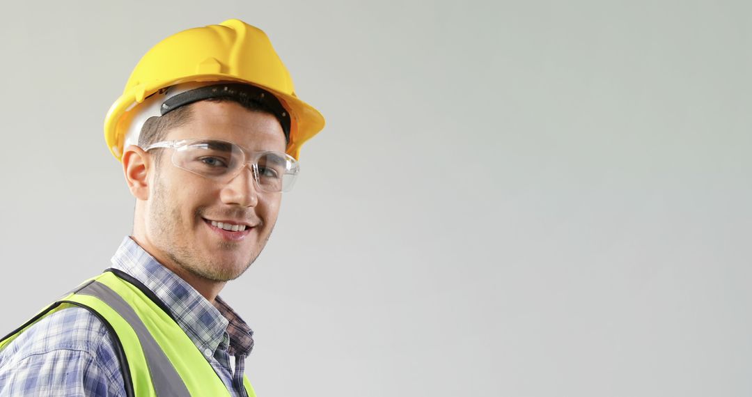 Smiling Construction Worker Wearing Yellow Hard Hat - Free Images, Stock Photos and Pictures on Pikwizard.com