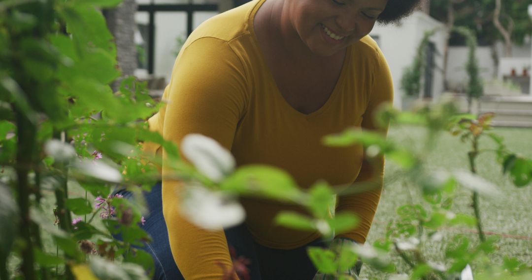 Woman Gardening with a Smile in Green Outdoor Space - Free Images, Stock Photos and Pictures on Pikwizard.com