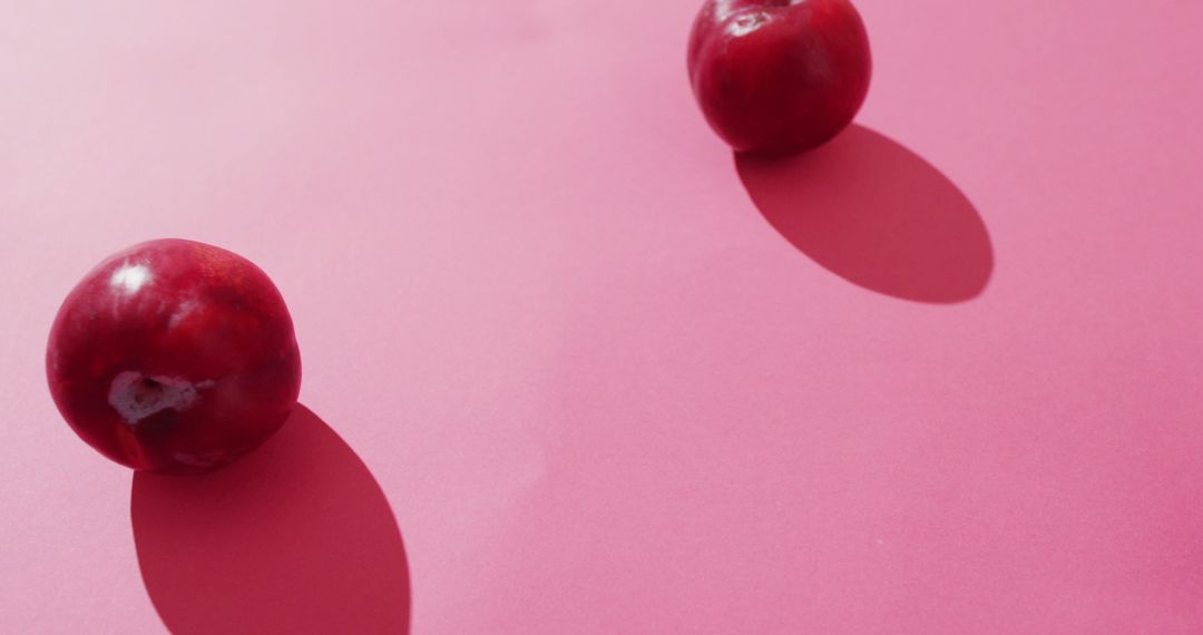 Image of fresh plums lying on pink surface - Free Images, Stock Photos and Pictures on Pikwizard.com