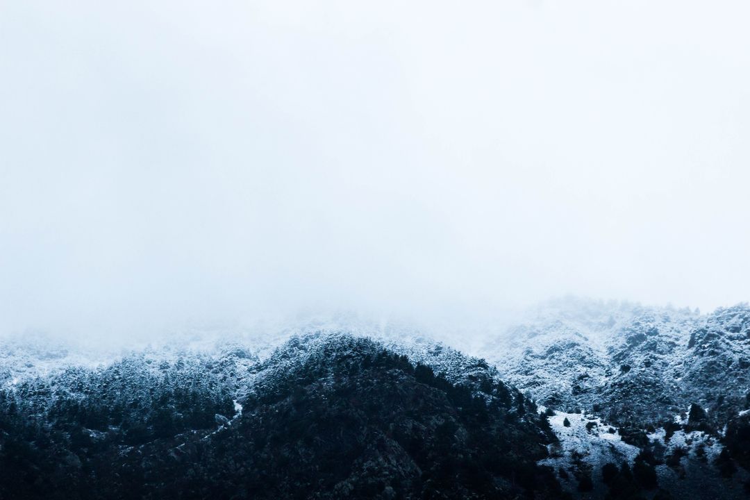 Snow-Covered Mountain Range with Misty Peaks