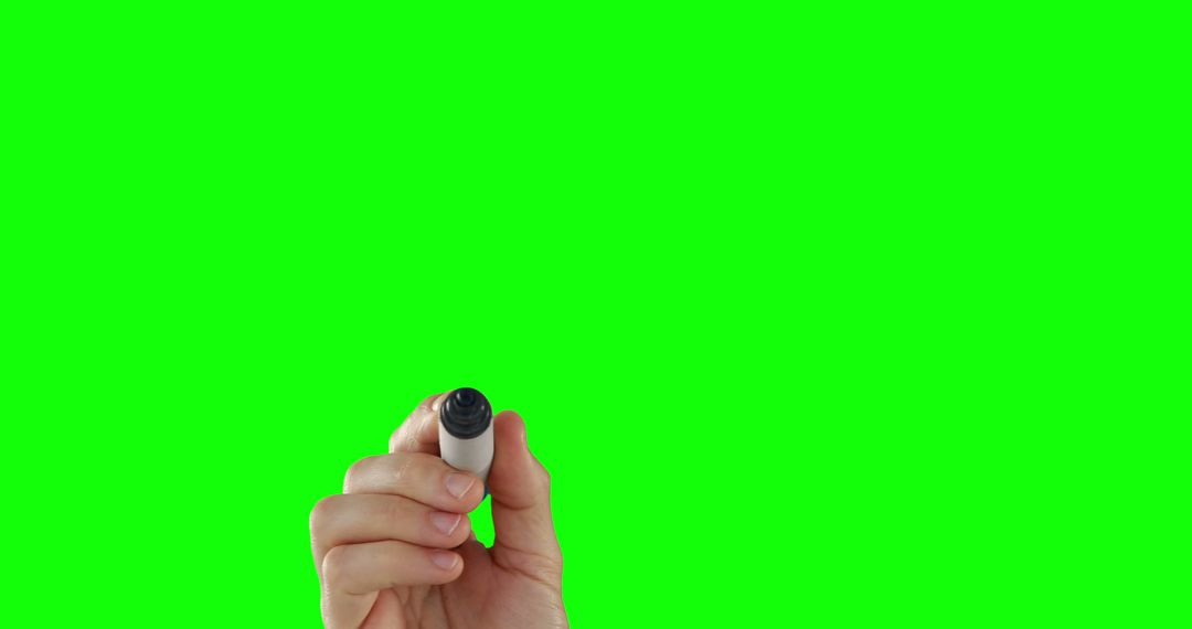 A Caucasian hand is holding a marker against a green screen background, with copy space - Free Images, Stock Photos and Pictures on Pikwizard.com