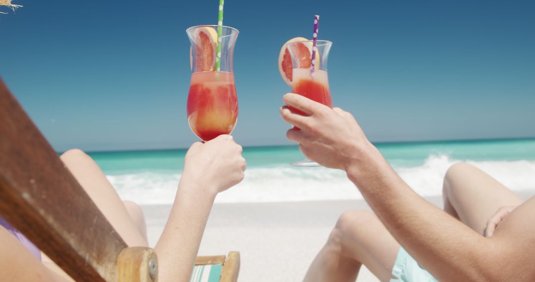 Couple Enjoying Tropical Cocktails on Beach Vacation - Free Images, Stock Photos and Pictures on Pikwizard.com