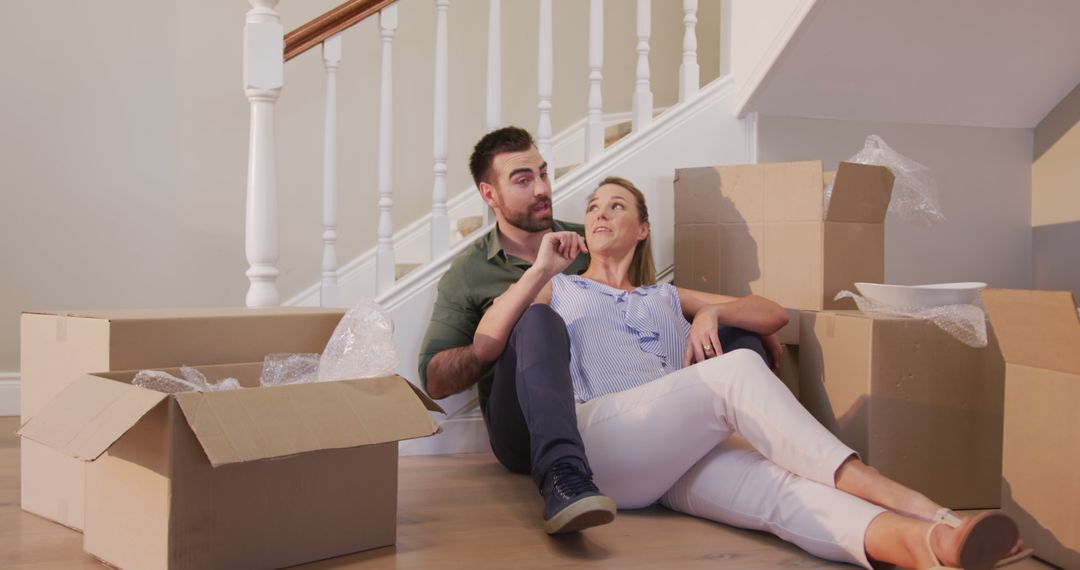 Couple Relaxing on Floor During House Move with Boxes - Free Images, Stock Photos and Pictures on Pikwizard.com
