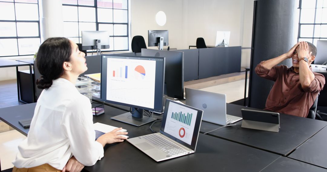 Professionals Collaborative Working on Financial Presentation in Modern Office