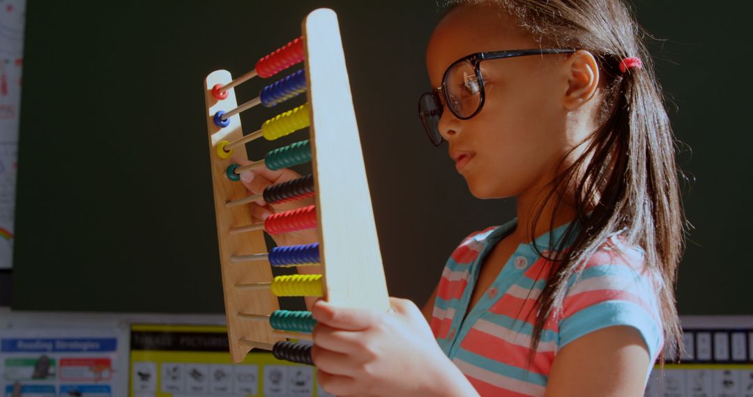 Schoolgirl Learning Math with Wooden Abacus